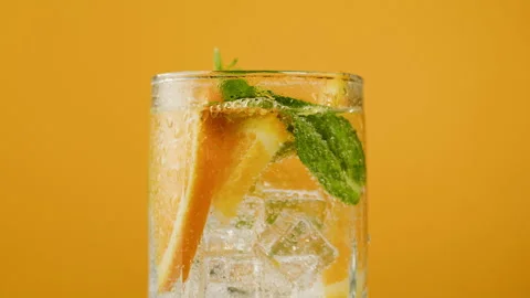 Oranges lemonade on orange background. Fruit citrus cocktail close-up texture 動画素材 196935526