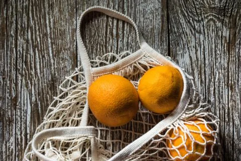 Oranges in a mesh bag. Stock Photos