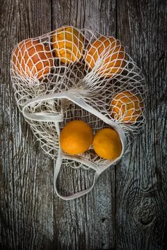 Oranges in a mesh bag. Stock Photos