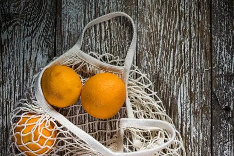 Oranges in a mesh bag. Stock Photos