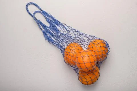 Oranges in a mesh string bag made of natural material. Environmental protection Stock Photos