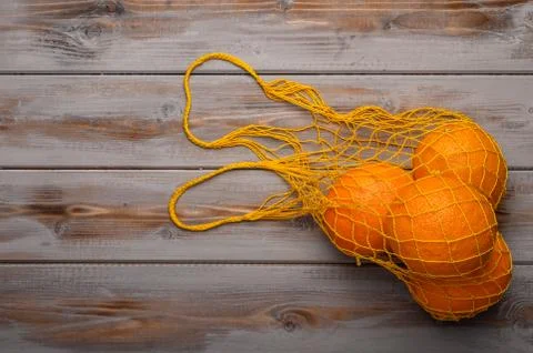 Oranges in a mesh string bag made of natural material. Environmental protection Stock Photos