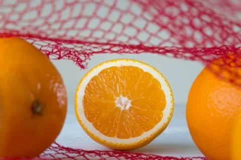 Oranges on the net Stock Photos