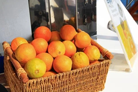 Oranges Next to a Fresh Squeezed Orange Juice Machine Stock Photos