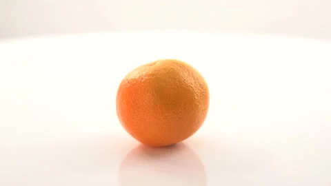 Oranges rotate on the stand .bright orange ripe tangerines rotate on their axis 動画素材 145404780