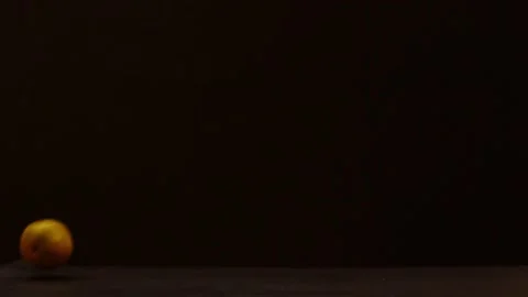 Oranges running across a black background Stock Footage 131250984