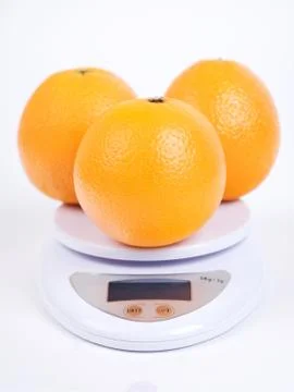 Oranges on scale Stock Photos