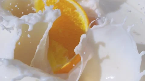 Oranges splashing into milk in slow motion 300fps Stock-Footage 288113211