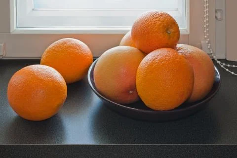 Oranges on the windowsill. Stock Photos