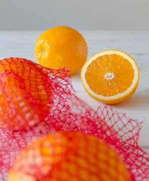 Oranges on a wooden table in the network Stock Photos