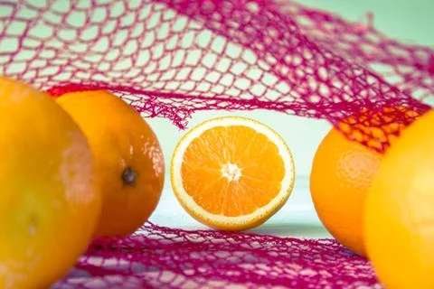 Oranges on a wooden table in the network Stock Photos