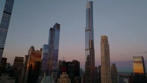 Orbit aerial of Central Park Tower above Billionaires row skyline at sunrise Vídeo Stock 344594286