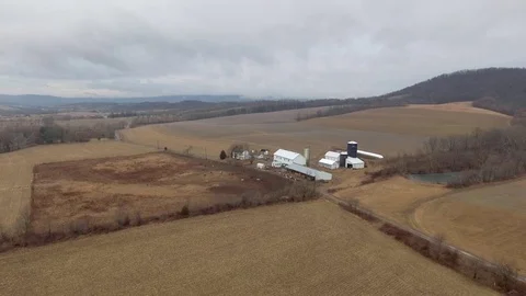 Orbit around cow farm on cloudy day Stock Footage 71760504