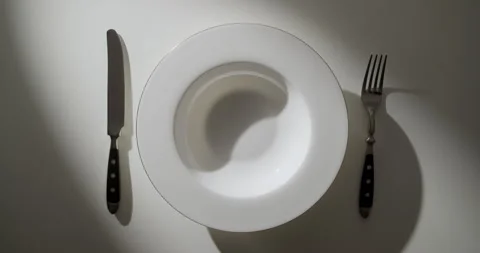 Orbit Around Empty White Luxury Plate with Knife and Fork and Long Shadows 動画素材 346696358