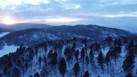 Orbit around mountain at dusk with sunset in winter Stock Footage 310569917