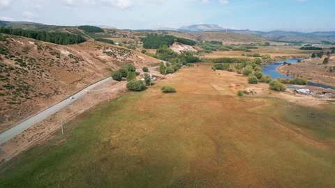 Orbit around rural valley with fields and pond. Liucura, Lonquimay, Chile Видео 331160812