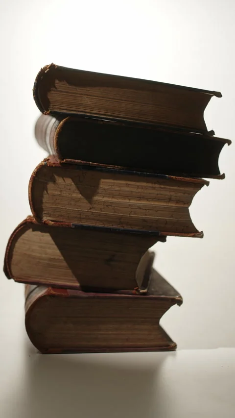 Orbit Around Stack of Vintage Books with Long Shadows in Mystic Light Stock Footage 346622983