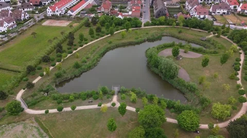 Orbit Around Unique Shaped Small Lake in Knokke-Heist | FlyLens 4K Stockbeeldmateriaal 309204861