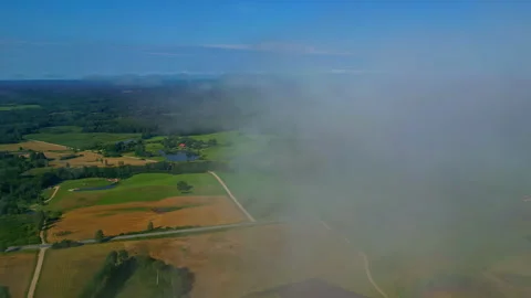 Orbit drone shot of clouds over the countryside with autumn colors Stock Footage 300268821