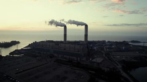 Orbit drone shot of Monroe Power Plant and Lake Erie at sunrise in Monroe 動画素材 302915917