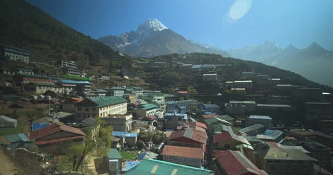 Orbit drone shot of Namche Bazaar Nepal showing colorful village houses beneath Stockbeeldmateriaal 337395480