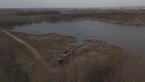 Orbit drone shot of old miner with lake solar farm and highway infrastructure Stock Footage 330189926