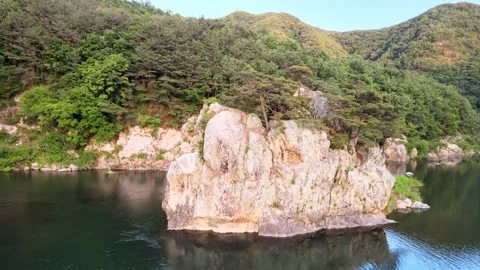 Orbit Drone Shot of Rock Island and River in South Korea Stock Footage 346233739