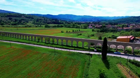 Orbit drone view ancient water pipline Arezzo hills landscape poppy field bloom  Video stock 240830818