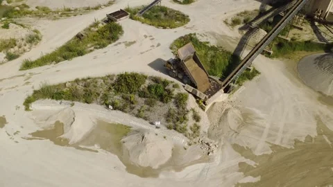 Orbit of a Dump Truck Tipping Material into a Feeder Hopper at a Gravel Pit Video stock 344105443