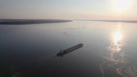 Orbit flight around large bulk carrier ship on the river sunrise Stock Footage 213072404