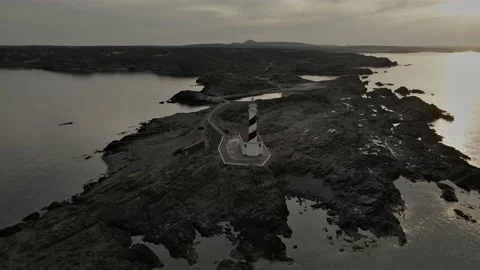 Orbit of lightouse in arid Menorca seashore with sunset , Balearic Islands Stock Footage 235180485