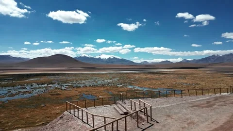 Orbit over rustic lookout platform overlooking vast altiplano bofedal wetland Video stock 335975449