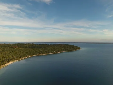 Orbit pan right along tip of peninsula coastline Stock Footage 76014752