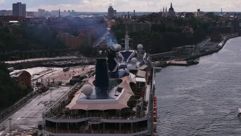 Orbit shot around top deck of large cruise ship. Air pollution coming from 스톡 동영상 249815457
