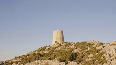 Orbit shot around watchtower in Formentor Mallorca 스톡 동영상 101718650