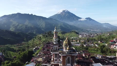 Orbit shot of the mosque with a background of mountains and surrounding villages Stock Footage 278789994