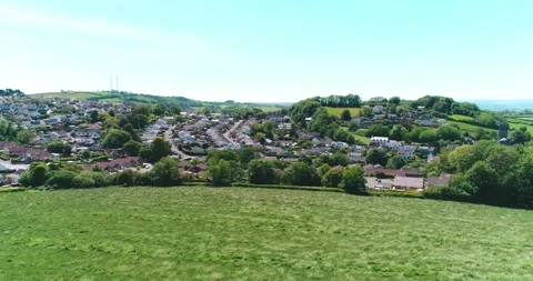 Orbit of small town in Devon England, with green field in the foreground. Video stock 155823694
