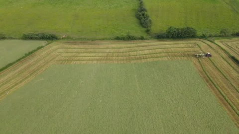 Orbit of tractor cutting grass Stock Footage 337462195