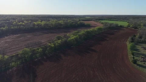 Orbit of Tree Line Dividing Plowed Farmland in Oklahoma Landscape Stock Footage 332128066