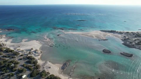 Orbit from turquoise lagoon into sunlight at Elafonisi, Crete Stock Footage 346723498