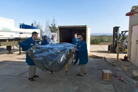 Orbital ATK technicians remove the second half of the payload fairing for ... 스톡 사진