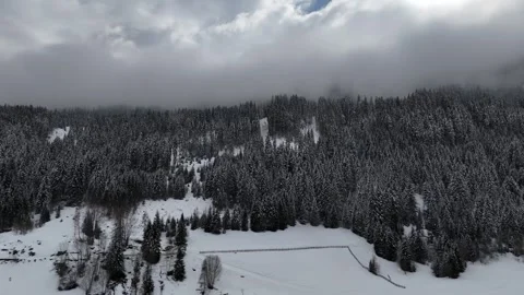 Orbital Drone Flight Around Snow-Covered Mountain Under Cloudy Sky in So Vídeo Stock 336652442