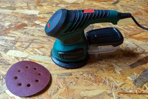 Orbital eccentric sander grinder machine for wood with grinding wheel on wood Stock Photos