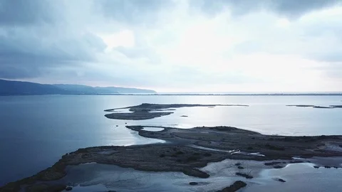 Orbital Flight over a lagoon lakes and islands, a cloudy sunset with reflections Stock Footage 97364368