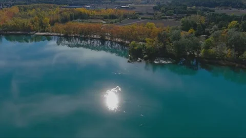 Orbital Glimpse of Sun's Reflection on a Verdant Lake Stock Footage 263352684