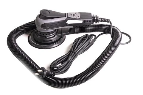 An orbital sander is placed on a plain white background. This tool is used fo Foto stock