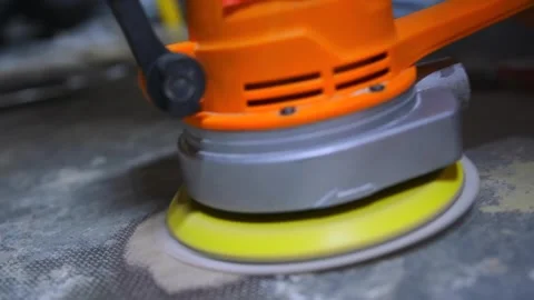 Orbital sander polishing rough surface in close-up, electric power tool Stock Footage 334862495