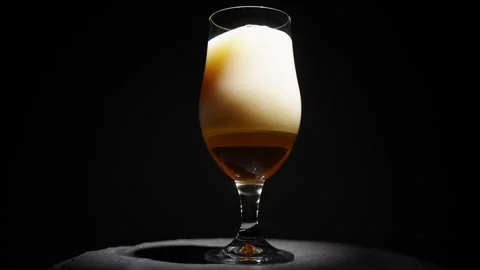 Orbital View of Golden Beer Bubbles with Frothy Head on Black Backdrop Stock Footage 302193955