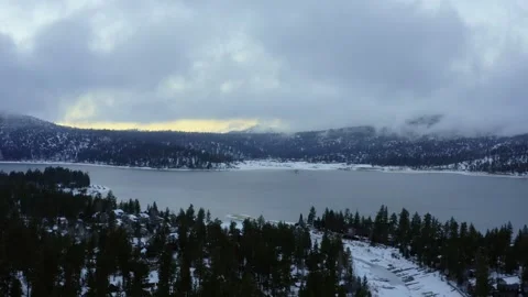 Orbiting Aerial view of Big Bear Lake, CA during a winter sunset 4k Drone Stock Footage 316179220