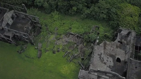 Orbiting aerial view of exploded ruins Corregidor Mike Long Barracks. Video stock 125738051